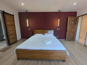 a bedroom with a large bed in a room at OCEAN Hotel Miami in Toamasina