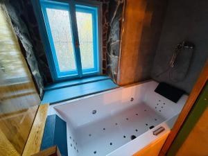 a bath tub in a bathroom with a window at Zázrak Wellness in Banská Štiavnica +42 photos