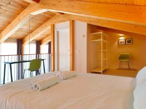 a bedroom with a large bed and a balcony at Apartamentos Mantería Lacort, Valladolid in Valladolid