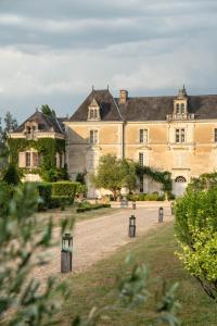 a large house with a driveway in front of it at Château De Chambiers in Durtal