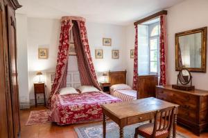 a bedroom with a bed and a table and a mirror at Château De Chambiers in Durtal +173 photos