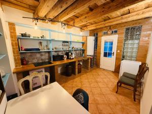 a kitchen with wooden ceilings and a table and chairs at Zázrak Wellness in Banská Štiavnica