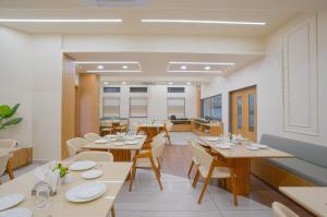 a dining room with wooden tables and chairs at V Club in Bhuj