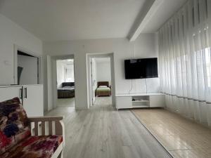 a living room with a flat screen tv on a wall at Nart Apartament in Prizren