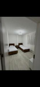 a room with two beds in a room with at Nart Apartament in Prizren