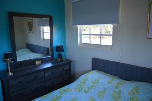 a bedroom with a mirror and a bed and a dresser at Casa Bista Montaña in Barber