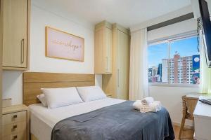a small bedroom with a bed with a window at Charming apartment in downtown Floripa EDC402 in Florianópolis