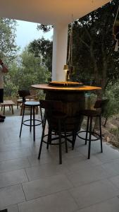a wooden table and chairs on a patio at Domo s eliga in Padru