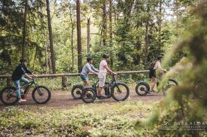 a group of people riding bikes on a trail at Paekalda Holiday Centre in Rummu