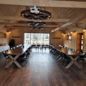 a large conference room with wooden tables and chairs at Paekalda Holiday Centre in Rummu