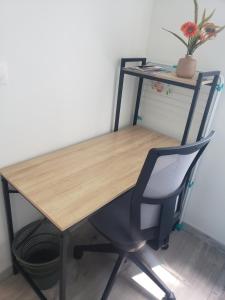 a wooden table with a chair and a desk at Cocon lumineux Euratech-CHU in Lille