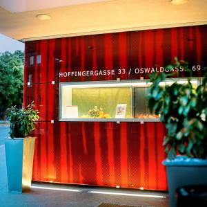 a store front with a red wall at Kyriad Vienna Altmannsdorf in Vienna