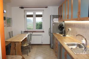a kitchen with a table and a counter top at Bocianówka 5 in Wężówka