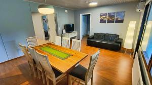 a living room with a table and chairs and a couch at Ventum Village in Punkaharju +35 photos