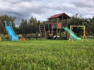 a playground with slides and a gazebo at Agroturystyka Zdrowo przez sad in Brzezinki
