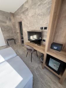 a room with two beds and a desk and a fireplace at Hotel Corona in Termoli +68 photos