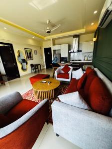 a living room with two couches and a table at Elysium Tower Luxury Apartments Islamabad Opposite Centaurus Mall in Islamabad