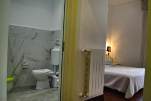 a bathroom with a toilet and a bed at B&B Palazzo Sant'Alfano in Catania +47 photos