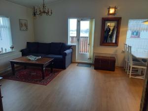 a living room with a blue couch and a table at Rólegt in Ísafjörður
