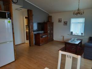 a living room with a refrigerator and a table at Rólegt in Ísafjörður