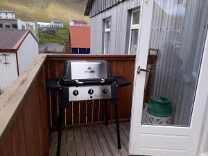 a grill on the balcony of a house at Rólegt in Ísafjörður