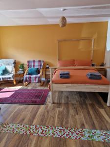 a bedroom with a bed and a chair and a rug at Fairways in Melrose