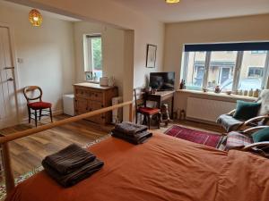 a bedroom with a bed and a desk and a window at Fairways in Melrose