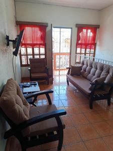 a living room with two couches and a table at Hostal Expansion in San Juan del Sur
