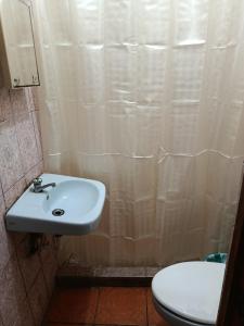a bathroom with a sink and a toilet at Hostal Expansion in San Juan del Sur