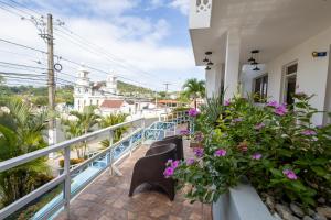 a balcony of a house with flowers on it at Casa Docia Hotel in Santa Bárbara de Samaná
