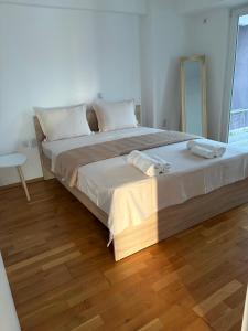 a bedroom with a bed with two towels on it at Matey Luxury Sky Apartment in Bitola
