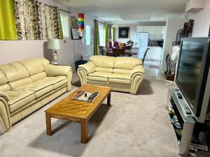 a living room with two couches and a coffee table at Imperial Ranchettes GuestSuite in Lone Butte