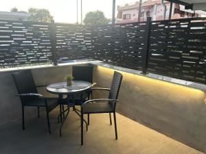 a table and chairs sitting on top of a balcony at Elia Apartments in Eretria