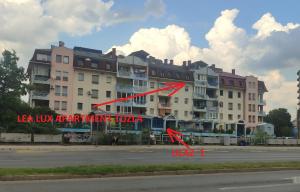 a large apartment building with a red arrow on it at Lea Lux apartment Tuzla in Tuzla
