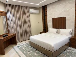 a hotel room with a bed and a window at ترند سويتس - TREND Suites in Al Baha +35 photos