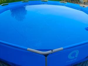 a large blue trampoline sitting on the ground at Zacisze pod lasem in Ruciane-Nida