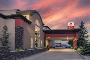 a building with a parking garage with a sunset at Best Western PLUS City Centre Inn in Edmonton