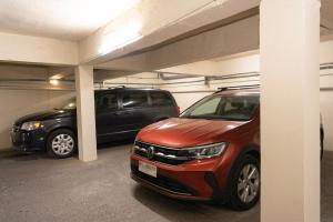 a parking garage with two cars parked in it at Hotel Qamiri in Arica