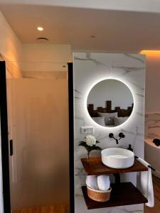a bathroom with a sink and a mirror at La Muraza in Villaviciosa