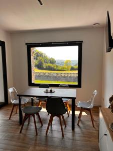 a dining room with a table and chairs and a window at La Muraza in Villaviciosa +16 photos