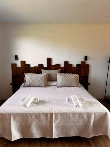 a bed with two white towels on top of it at La Muraza in Villaviciosa