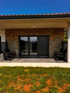 a house with two chairs sitting on a patio at La Muraza in Villaviciosa
