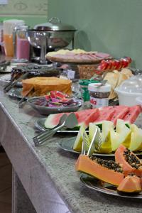 a buffet with plates of food on a table at Hotel Vivenda das Cachoeiras in Brotas