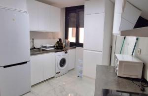 eine Küche mit Waschmaschine und Spüle in der Unterkunft Modern central flat in Ceuta
