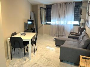 ein Wohnzimmer mit einem Tisch und einem Sofa in der Unterkunft Modern central flat in Ceuta