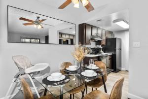 a dining room with a glass table and chairs at Tempe Hideaway Luxe Amenities Parking in Tempe