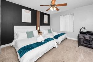 a bedroom with two beds and a ceiling fan at Tempe Hideaway Luxe Amenities Parking in Tempe