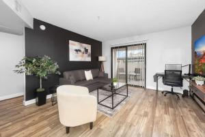 a living room with a couch and a television at Tempe Hideaway Luxe Amenities Parking in Tempe