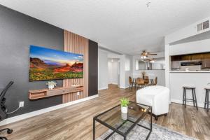 a living room with a white chair and a table at Tempe Hideaway Luxe Amenities Parking in Tempe +30 photos