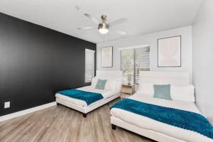 a bedroom with two beds and a black wall at Chill 2BR Near ASU, Pool, Grill, Parking,Pet Frndly in Tempe